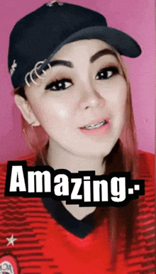 a woman wearing a hat and a red shirt with the words amazing on the bottom