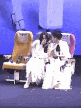 three women in white dresses are sitting in airplane seats with the word jet on the back