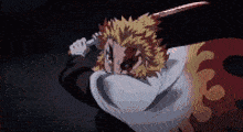 a man is holding a sword in his hand .