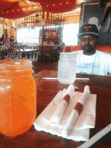 a man wearing a t-shirt that says i have disappointed sits at a restaurant table