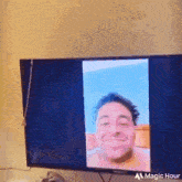 a tv with a picture of a man on it that says magic hour on the bottom