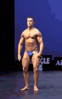 canadian bodybuilder young man flexing physique bluetrunks posingtrunks hot physique bodybuilding speedo biceps doublebi pose ripped stud gaystud