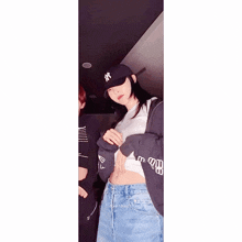 a woman wearing a ny hat and a sweatshirt with the word hk on the sleeves