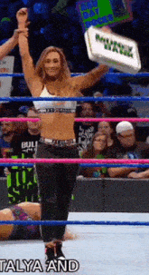 a woman in a wrestling ring is holding up a cooler that says new day rocks on it