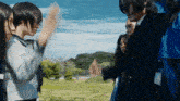 a group of people are standing in a field and one of them is wearing glasses
