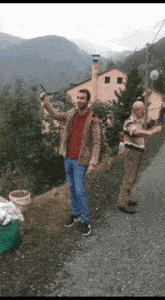 a man in a brown jacket is holding a gun in his right hand