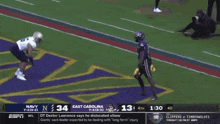 a football game is being played between the navy and east carolina teams