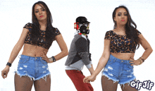 a woman in a leopard print crop top stands next to a man in a mask