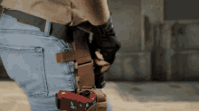 a person holding a gun with a holster that says ' a ' on it