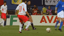 a group of soccer players are playing a game in front of a banner that says ava