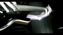 a close up of a person playing a guitar