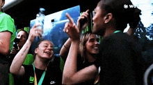 a woman wearing a nike shirt is taking a picture with her phone