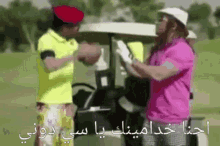 two men standing next to a golf cart with arabic writing on the bottom
