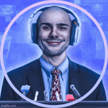 a man wearing headphones stands in front of a podium with microphones