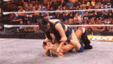 two women are wrestling in a ring with a sign that says nxt in the background