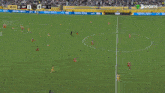 a soccer game is being played in a stadium with a banner that says " football unites "