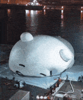 a large white balloon with a face on it