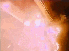 a close up of a person 's arm with a purple light coming out of it