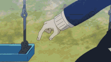 a person 's hand is reaching out to a blue swing