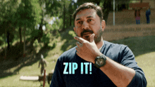 a man in a blue shirt with the words zip it on it