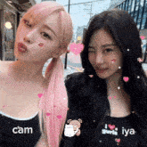 two girls are posing for a picture and one of them is wearing a shirt that says iya