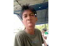 a young boy wearing a champion shirt making a face