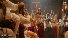 a group of people are dancing in front of a banner that says pranay varma