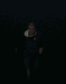 a blurry picture of a man wearing a black shirt with the letter s on it