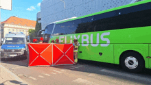 a green and white bus with the word bus on the side