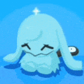 a blue cartoon character with long ears is sitting on a blue surface with a star in the background .