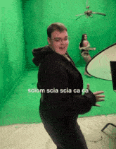 a man is dancing in front of a green screen with the words sciom scia scia ca ca written on the bottom