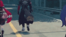 a man and a woman are walking down a street .