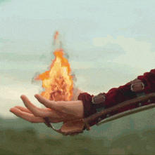 a person is holding a fireball in their hands