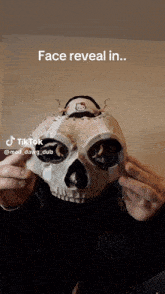 a person holding a skull with a hello kitty hat on top