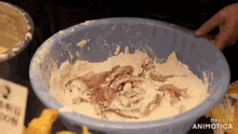 a blue bowl filled with flour and meat with the words made in animatica on the bottom