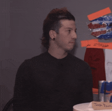 a man in a black shirt stands in front of a sign that says " josh dun "