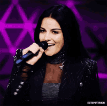 a woman singing into a microphone with the words edits portirroni on the bottom right