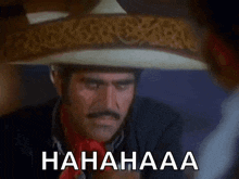 a man wearing a sombrero is laughing while holding a glass of water .