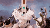 a white robot with a green light on its head and the word pan on the front