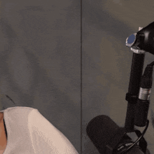 a woman is smiling while holding a microphone