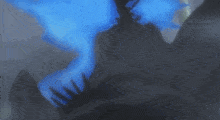 a person is holding a blue glowing object in their hands .