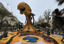 a statue of a monster made out of oranges