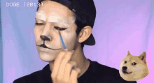 a man is applying makeup to look like a doge with a picture of a doge in the background