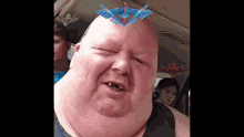 a man with a crown on his head looks at the camera