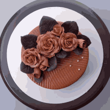 a chocolate cake with chocolate roses and leaves
