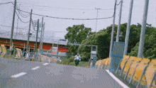 a person riding a motorcycle down a road with a sign that says ' no smoking ' on it