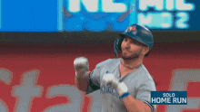 a baseball player with a solo home run sign in the background