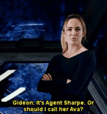a woman with her arms crossed is talking to gideon who says it 's agent sharpe