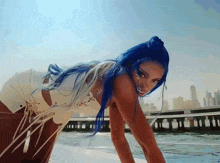a woman with blue hair is on a boat