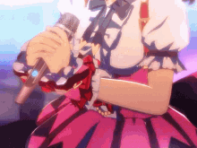 a girl in a pink dress is holding a microphone in her hand